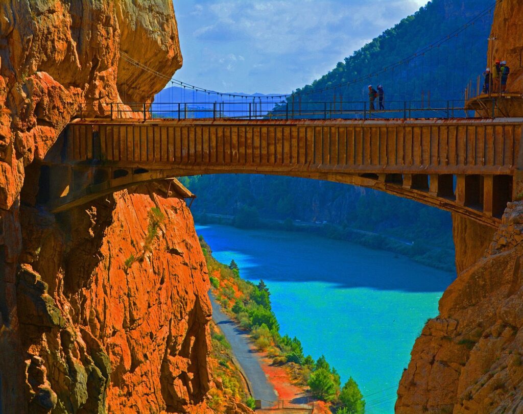 Footbridge of the Caminito del Rey spanning the narrow Gaitanes gorge above turquoise water